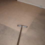 Carpet extraction example: lighter cleaned carpet beside a darker soiled area, with an extraction wand visible.